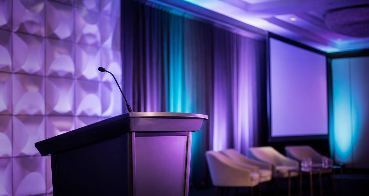 Conference stage set for a dermatology presentation on onychomycosis